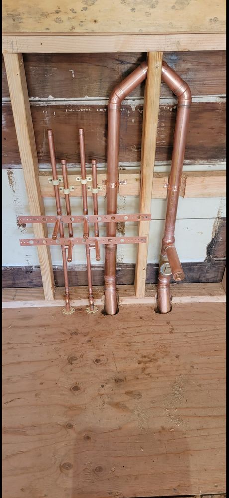 New copper repipe stub-outs and supply lines installed in a Fresno home wall cavity