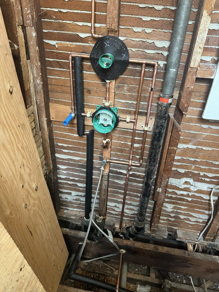 Copper water heater supply lines with pressure regulator, expansion tank and TPR valve in a Fresno home